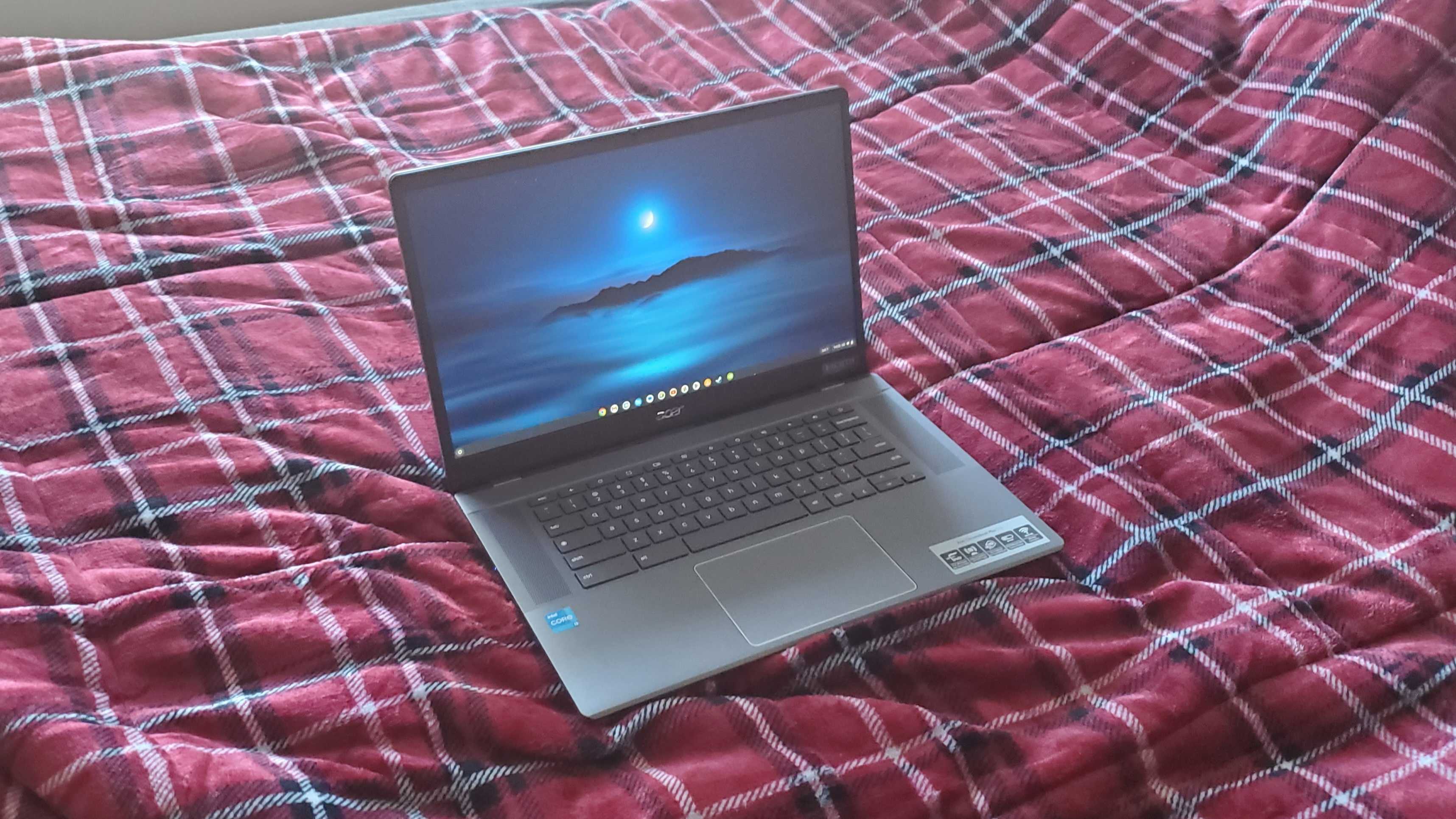 chromebook plus laptop sitting on bed