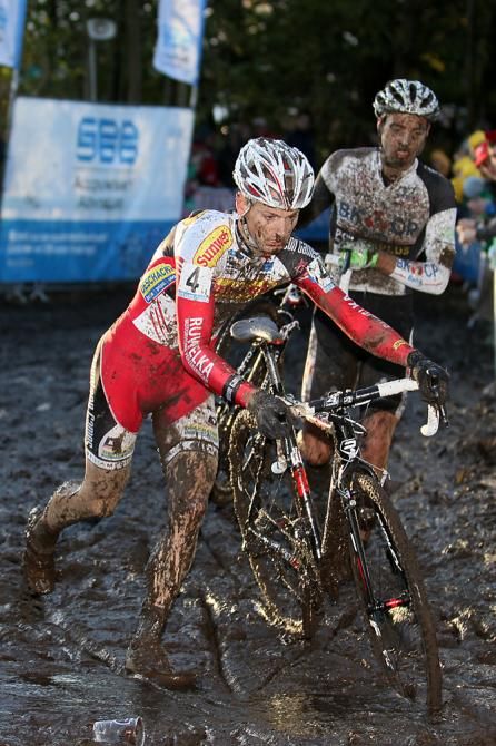 Kevin Pauwels splashes through the mud puddle