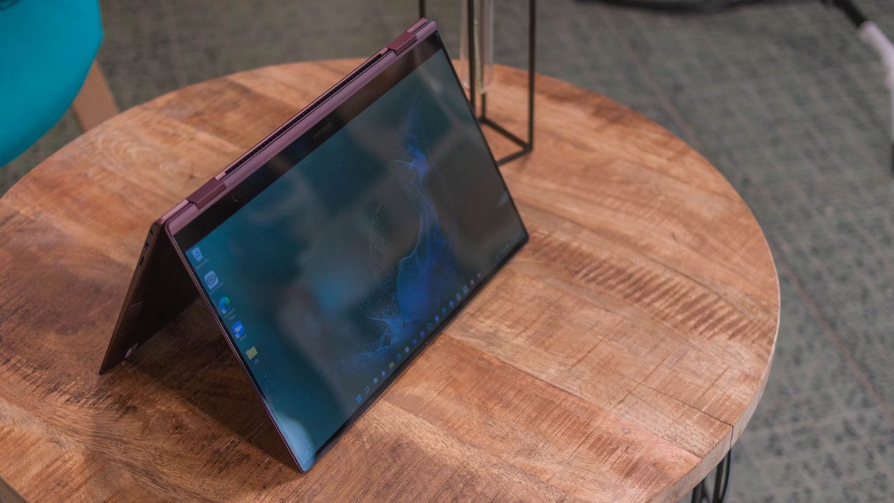 A photograph of the Samsung Galaxy Book2 Pro 360 on a table in tent mode