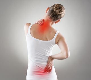 A woman has pain in her neck and back