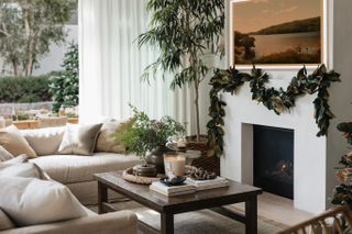 a modern fireplace with magnolia garland