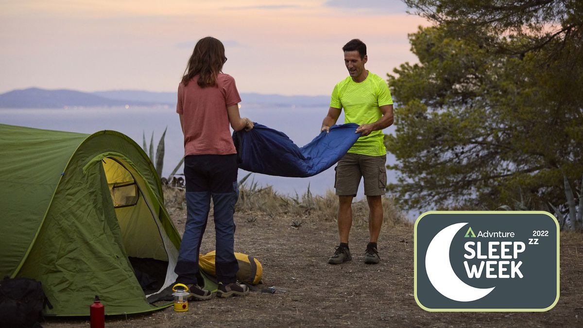 Two people folding sleeping bag