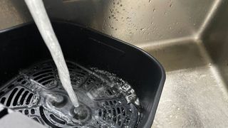 The Instant 4-in-1 Air Fryer drawer being washed