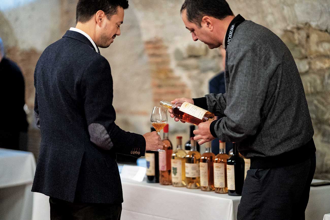Man pouring wine into glass at Tsinandali Wine Symposium
