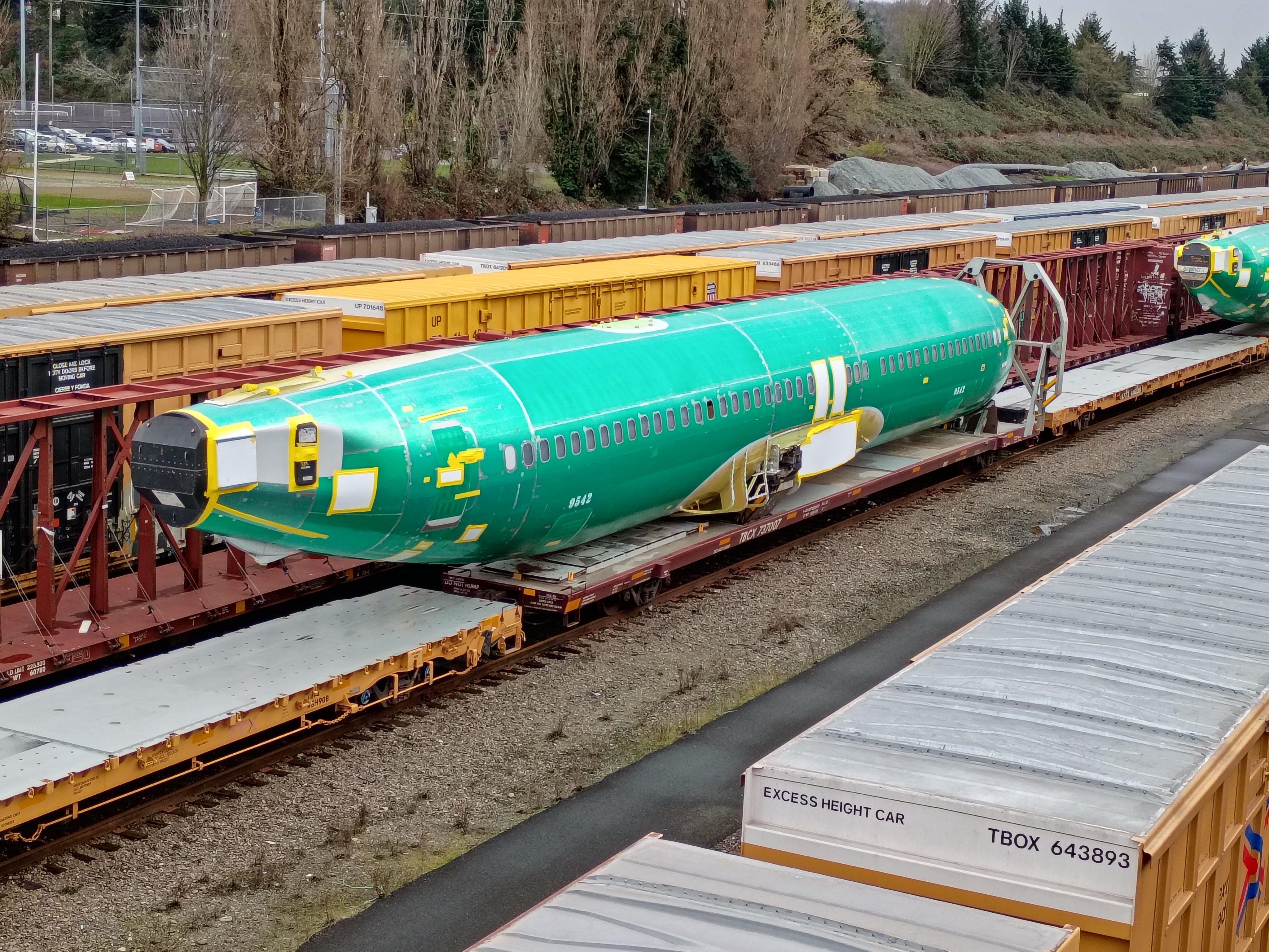 An airplane fuselage on a train