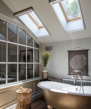 freestanding bath positioned below velux skylights