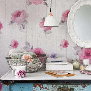 bedroom with rose wallpaper and mirror