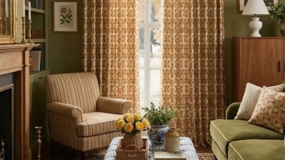 Retro neutral living room featuring a cozy mix of upholstered furniture, woven accents, and geometrically patterned curtains
