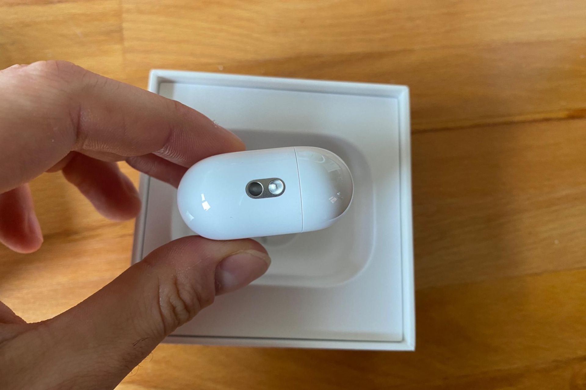 Male cyclist holding the case of the Apple AirPods Pro 2