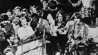 The Beatles perform Hey Jude with a crowd of backup singers in 1968