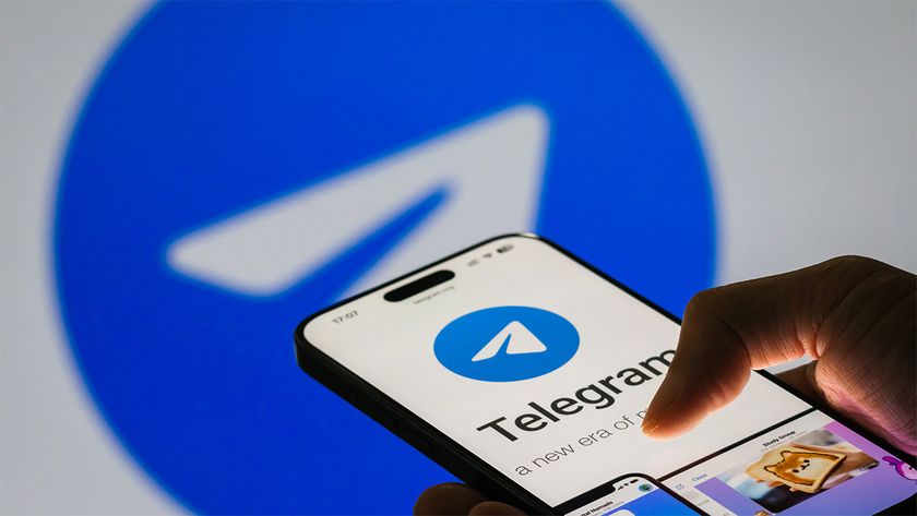 Telegram being used on a smartphone, with large Telegram logo in background