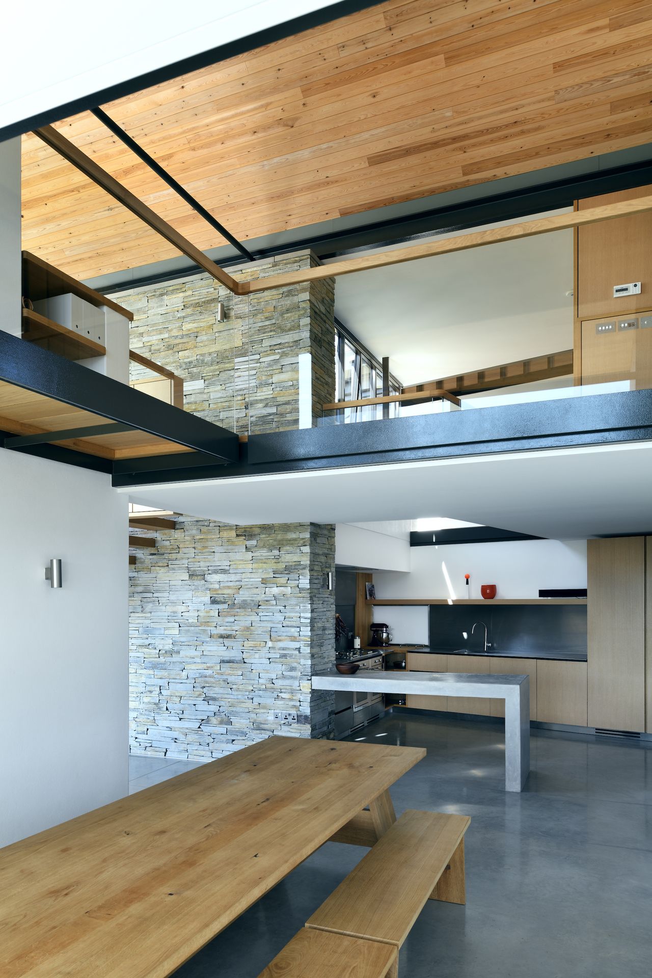 dining space with gallery landing above