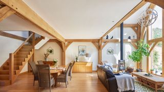 open plan living dining room with double height space in oak frame home