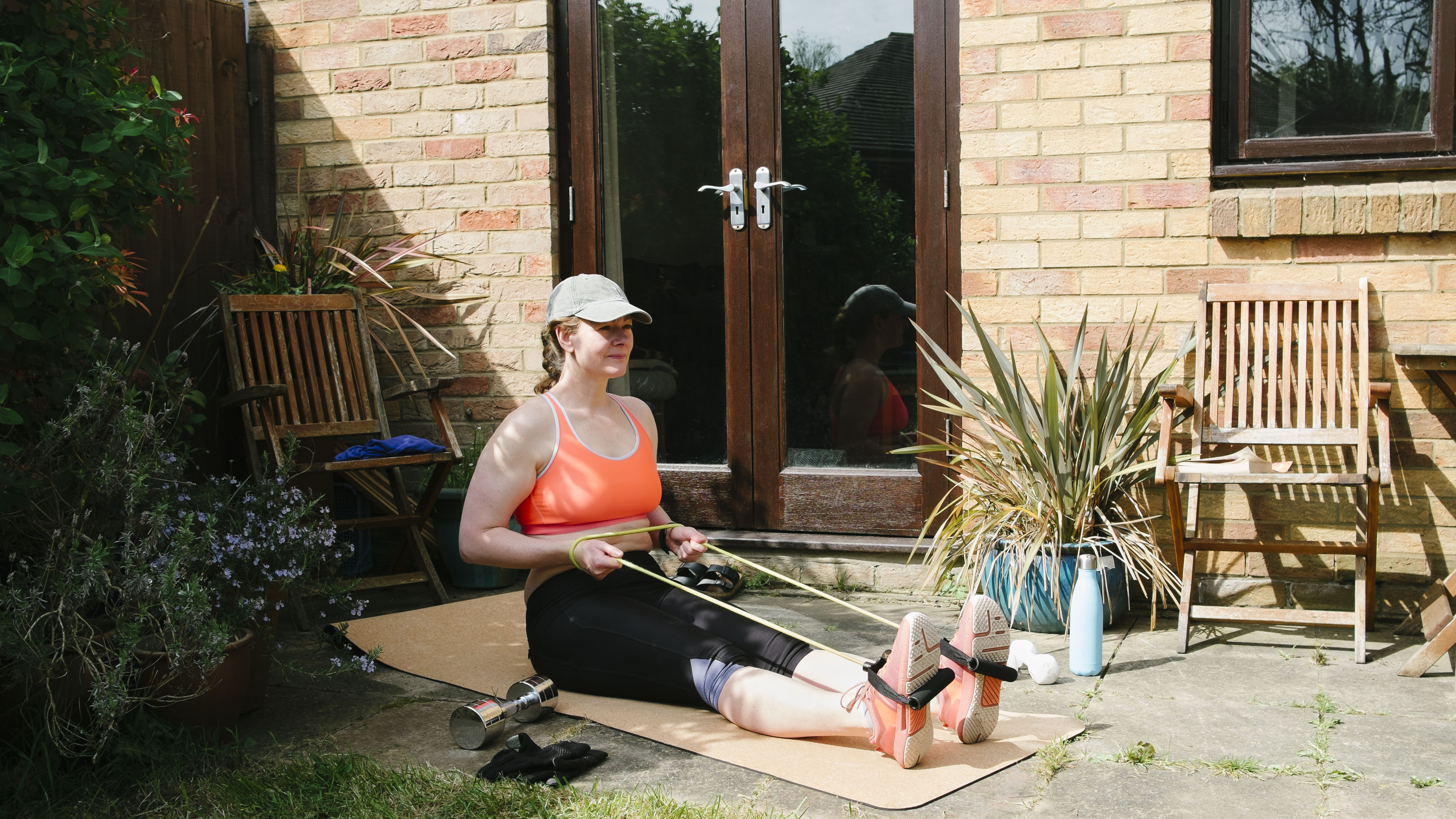 Woman using resistance bands in garden