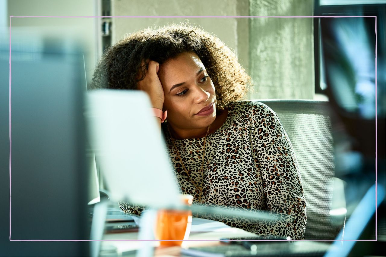 A woman looking stressed while at work