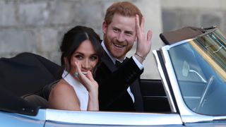 Prince Harry, Duke of Sussex and Meghan, Duchess of Sussex wave as they leave Windsor Castle after their wedding
