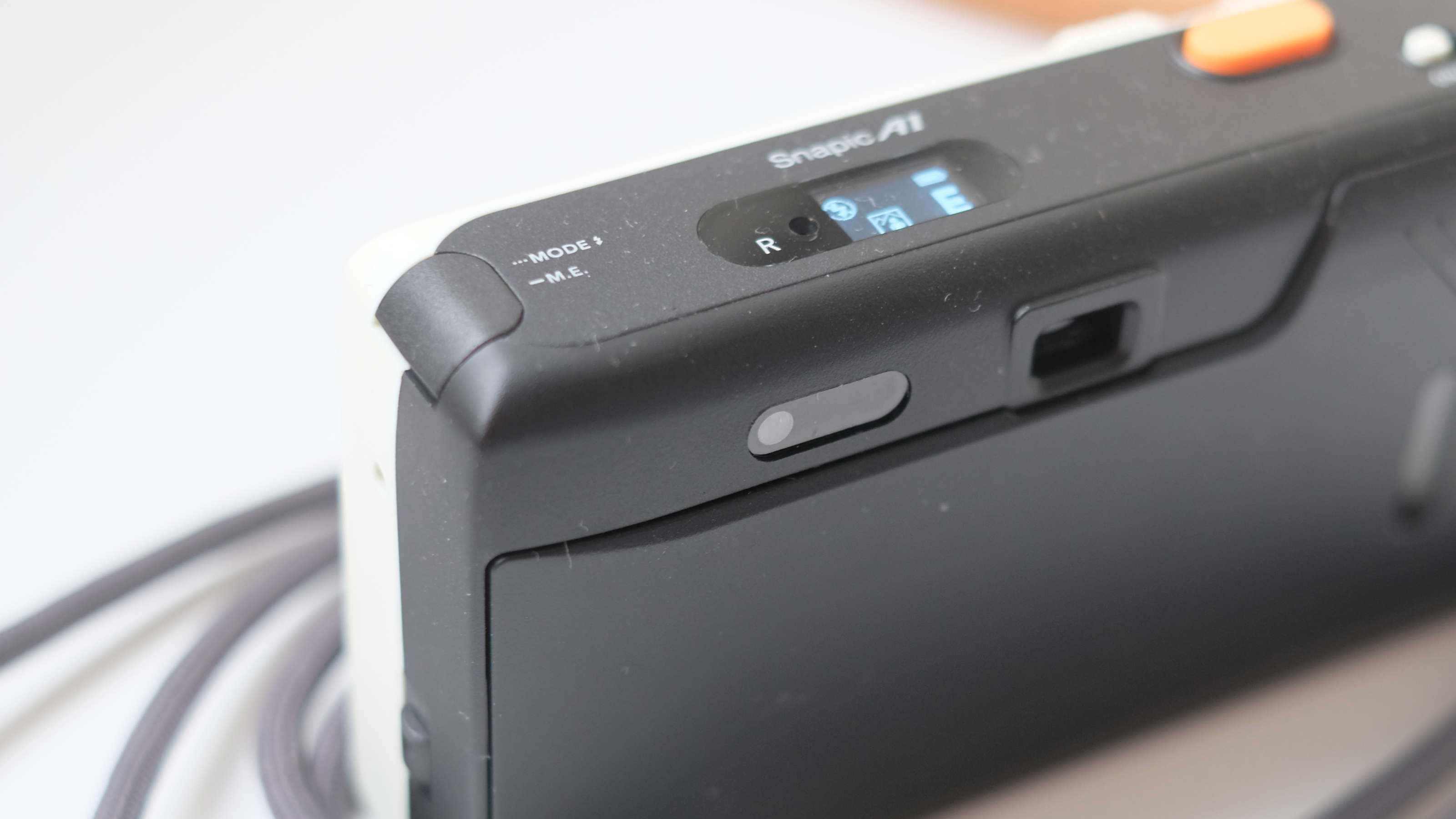 Photograph of Kodak Snapic A1 point-and-shoot film camera showing close-up of Mode and M.E. button