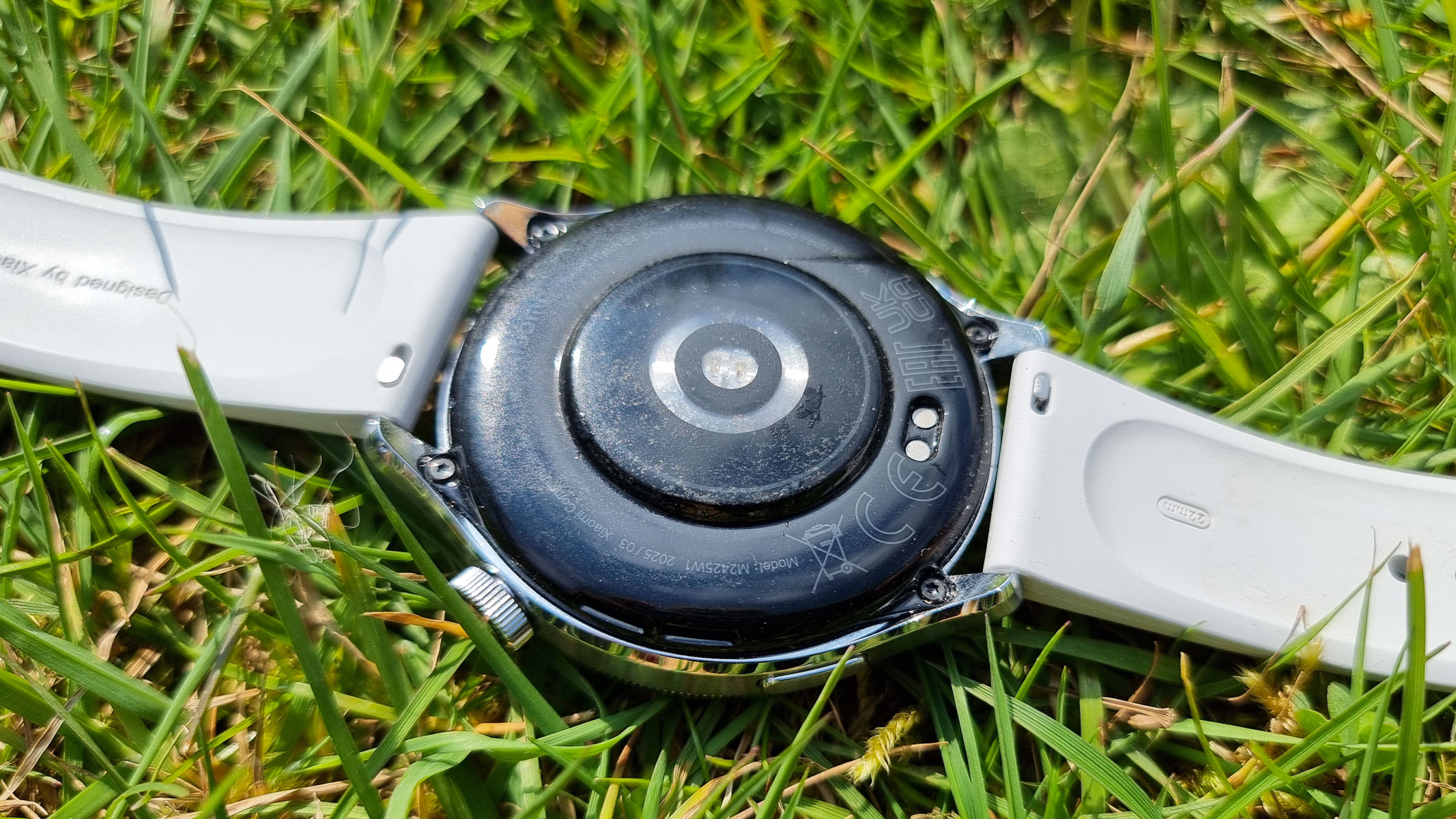 The Xiaomi Watch S4, a close-up picture of the sensors and charging port