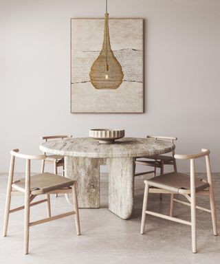 beige dining room with stone round table and pale wood dining chairs