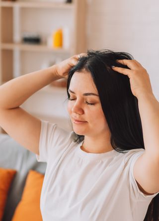 Woman massaging scalp