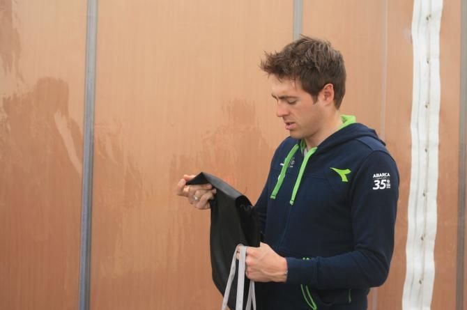 Alex Dowsett (Movistar) has a look to see what's inside his goody bag