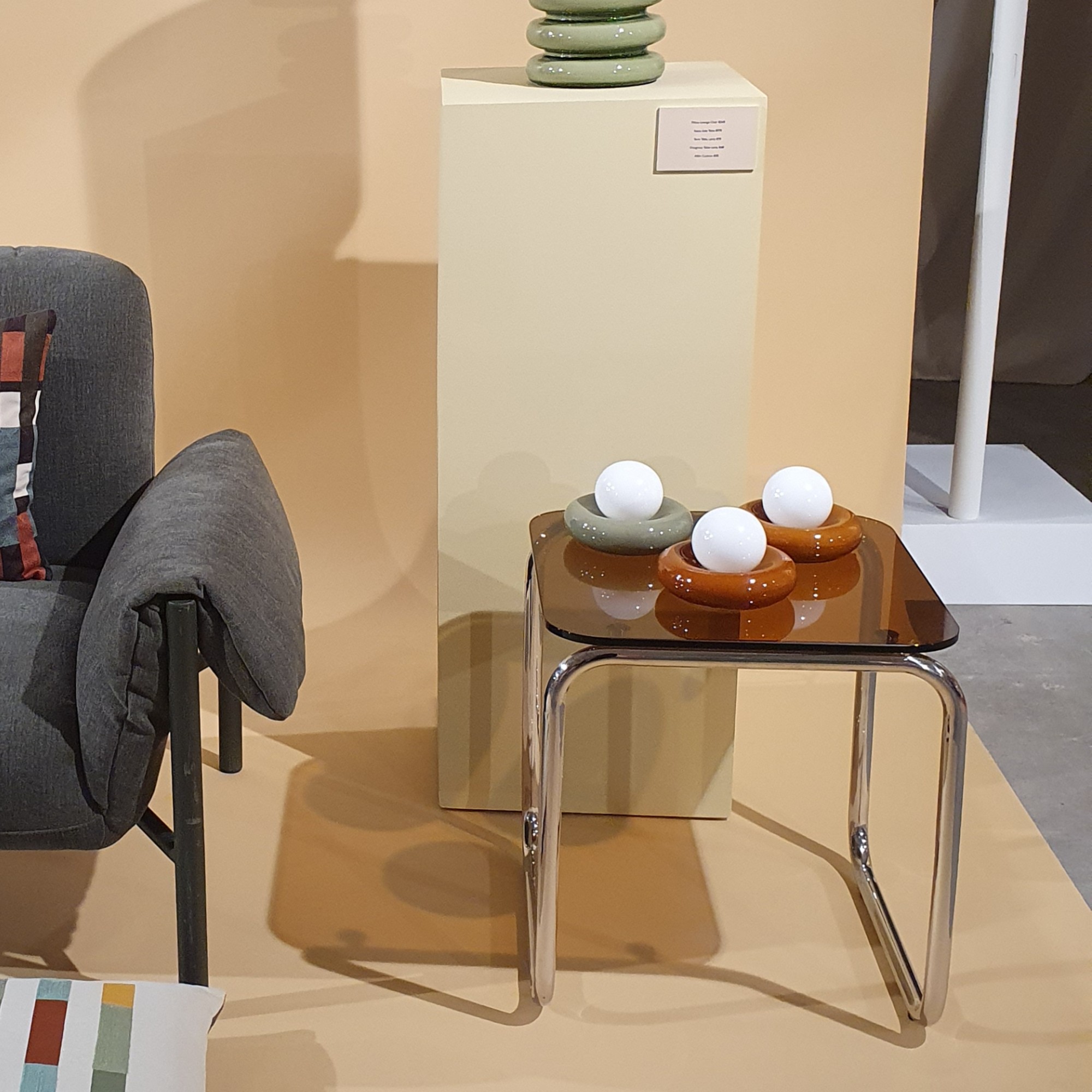 An accent chair next to a side table displaying donut table lamps at the John Lewis spring/summer 2026 press show