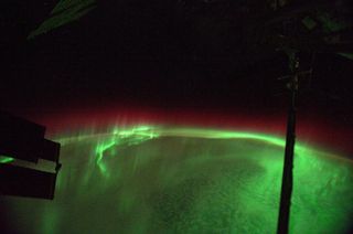Red and green auroras glow below the International Space Station in this photo from Alexander Gerst posted to Twitter on Aug. 29, 2014.