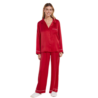 christmas gifts for her - woman wearing red silk pyjamas with white piping detail