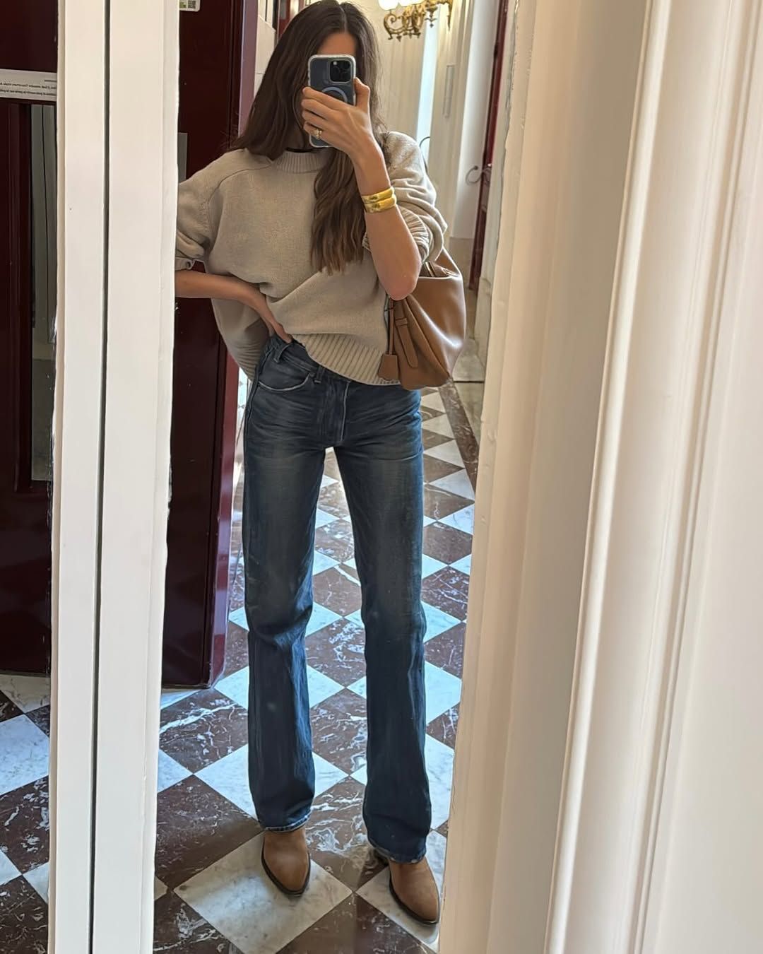 woman wearing straight-cut jeans and grey sweater