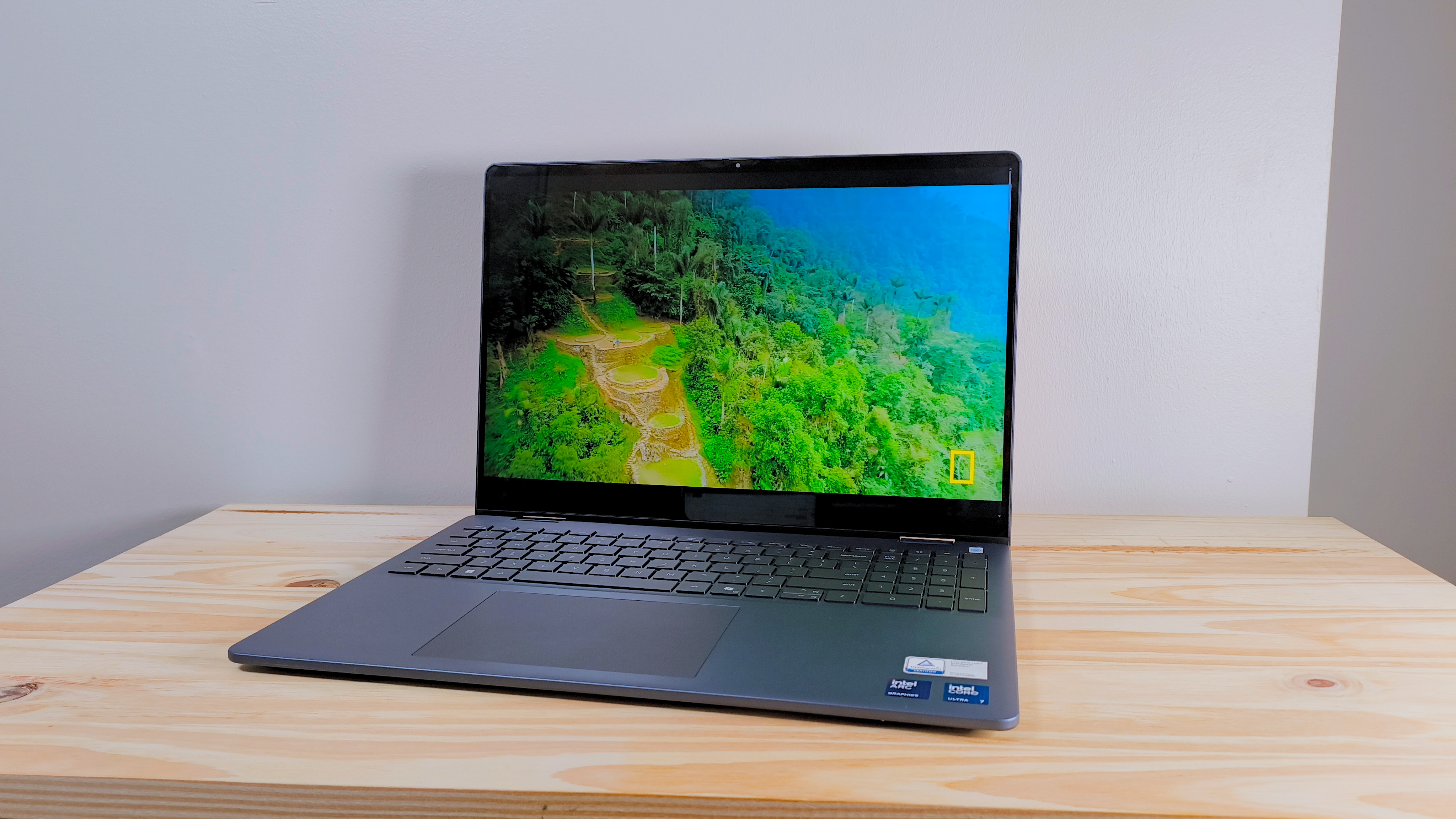 The Dell 16 Plus 2-in-1 on a wood table