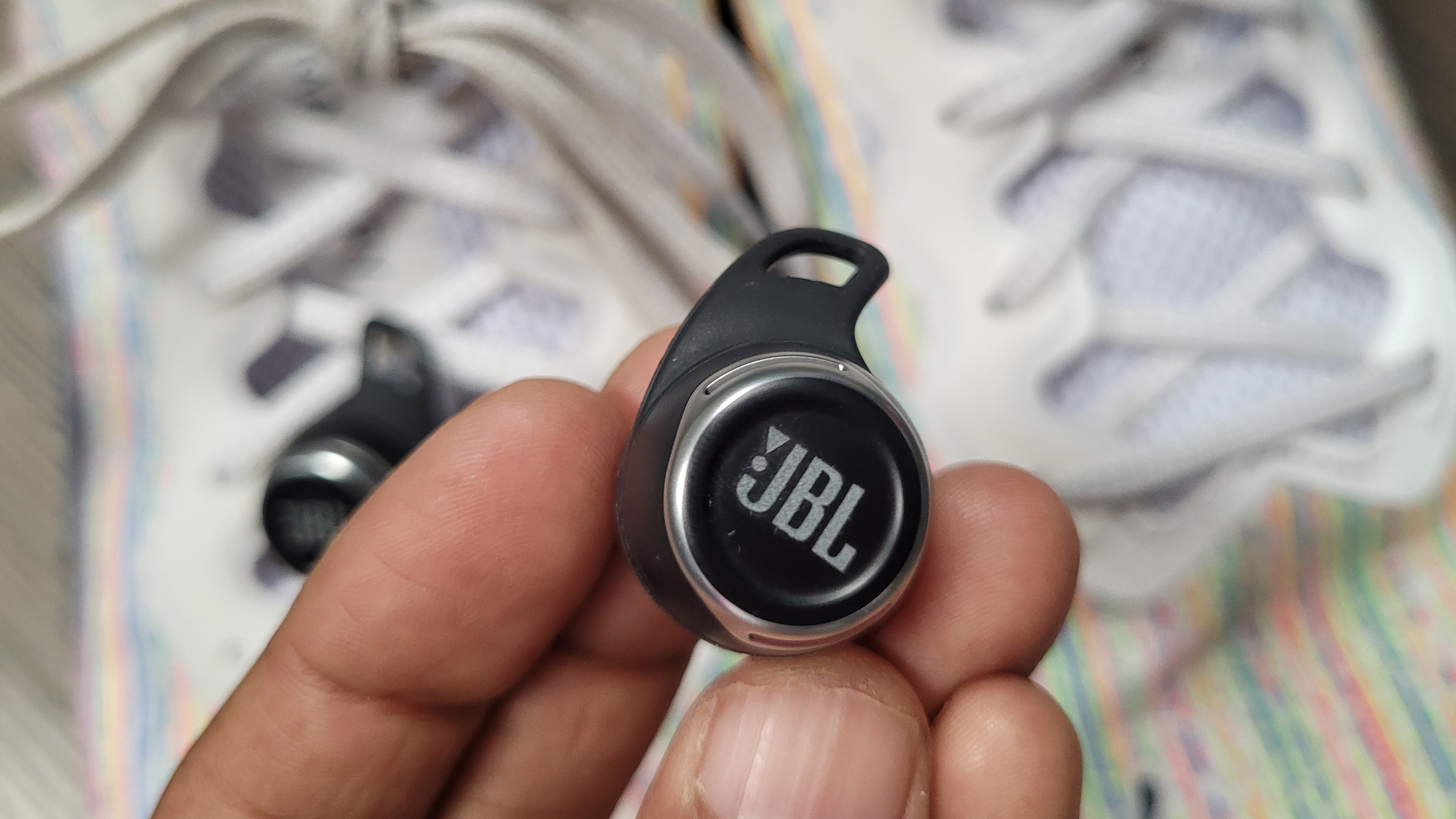 a closeup of the jbl reflect flow pro earbud