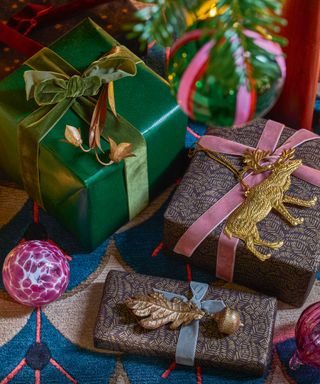 Christmas decorations with foliage and flowers, Christmas baubles and wrapped Christmas present.