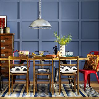 dining room with dining area with panelled wall and wooden dining set