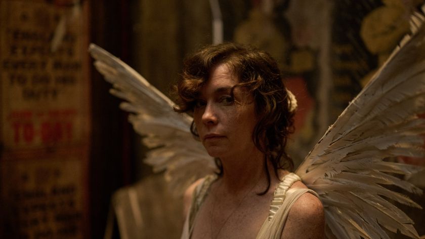 Julianne Nicholson wearing angel wings as Kate Galloway in Dope Girls.