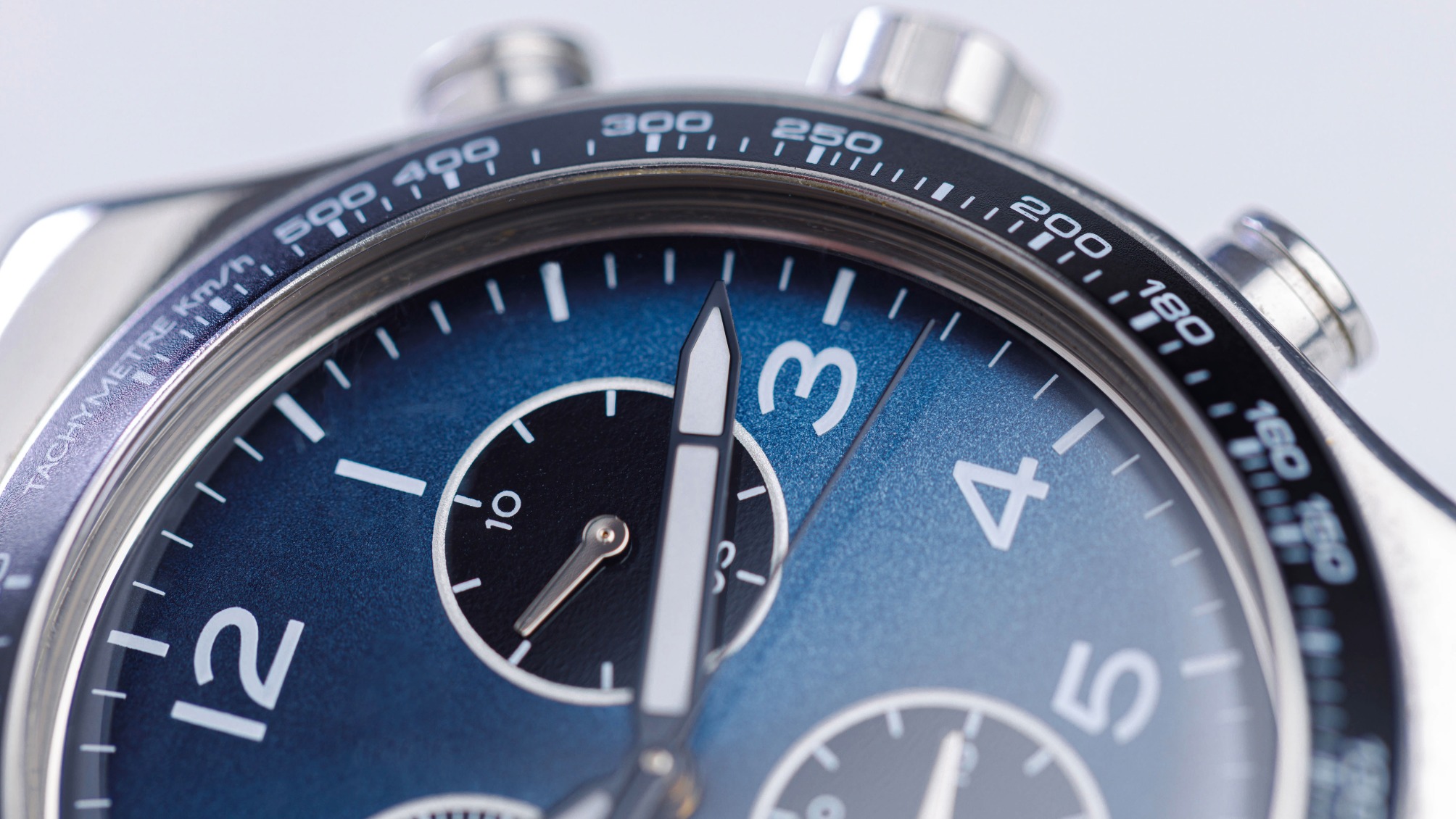 Close up of luxury chronograph watch dial with blue face