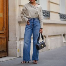 a woman wears wide-leg jeans