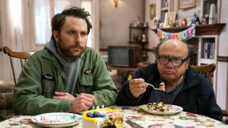 Charlie and Frank sitting at table eating cake in It's Always Sunny in Philadelphia Season 16