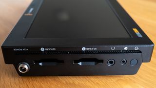 Close up of ports on a Blackmagic Video Assist 7 12G HDR video monitor on a wooden surface