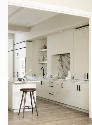 Kitchen with white cabinets and islands and black handles