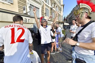 England fans, one in a 'Southgate 12' shirt, prepare for the game against Ukraine
