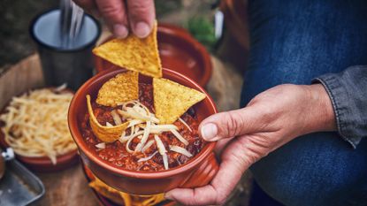 A person eating chilli con carne