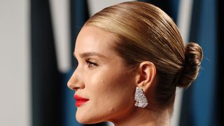 rosie huntington whiteley with her hair in a tight low bun which is a youthful hairstyle