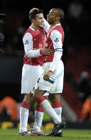 Robin Van Persie, left, celebrates an Arsenal goal with Thierry Henry