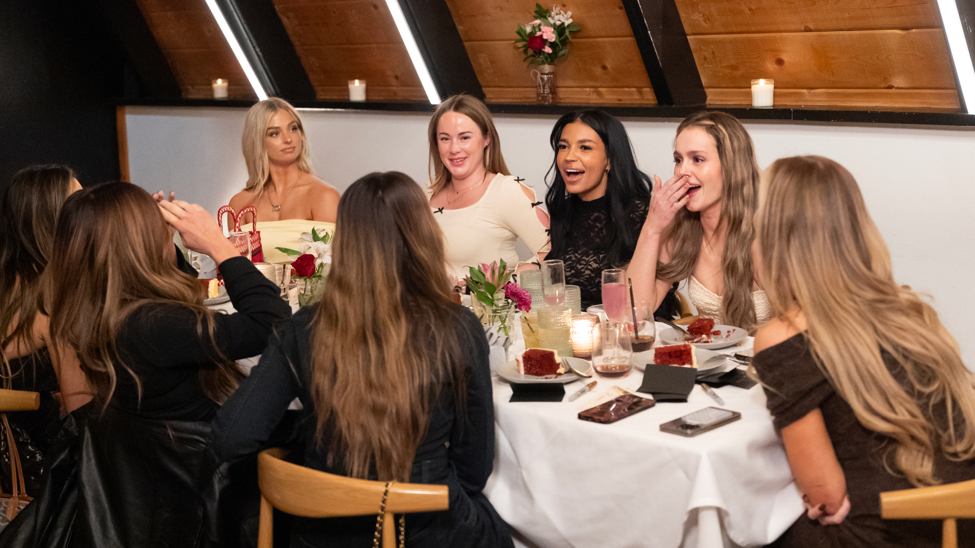 A table of women chatting over dinner, in 'The Secret Lives of Mormon Wives' season 2.