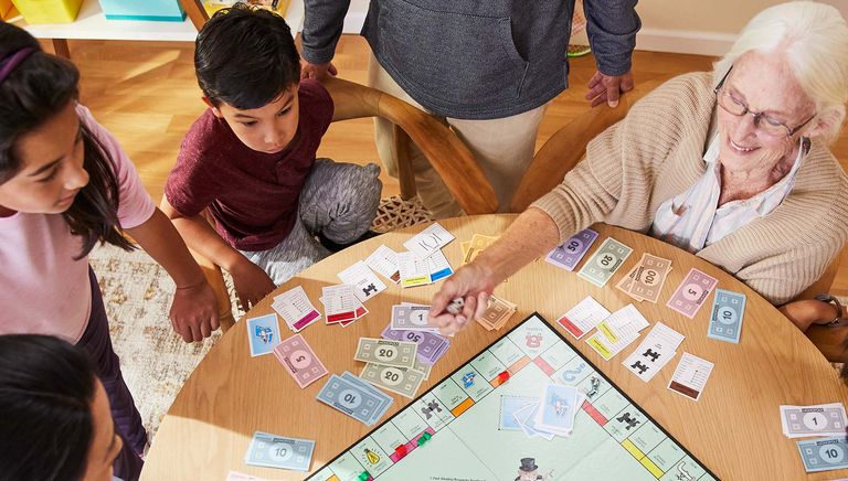 Family sat around the table playing Monopoly, one of the games from House of Fraser
