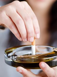 woman stubbing out cigarette