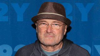Phil Collins posing for a photograph in 2016