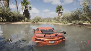 A screenshot from Forza Horizon 5 showing a Corvette half-submerged in swampy water