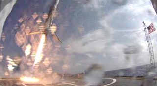 The first stage of SpaceX's Falcon 9 rocket attempts to land on an unmanned ship in the Atlantic Ocean on April 14, 2015. The rocket stage tipped over shortly after touching down, SpaceX CEO Elon Musk said.