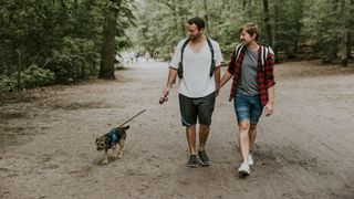 Two men walking dog